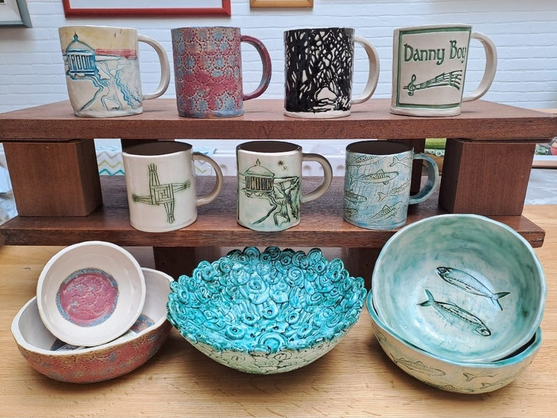 Display shelf of handmade mugs and bowls